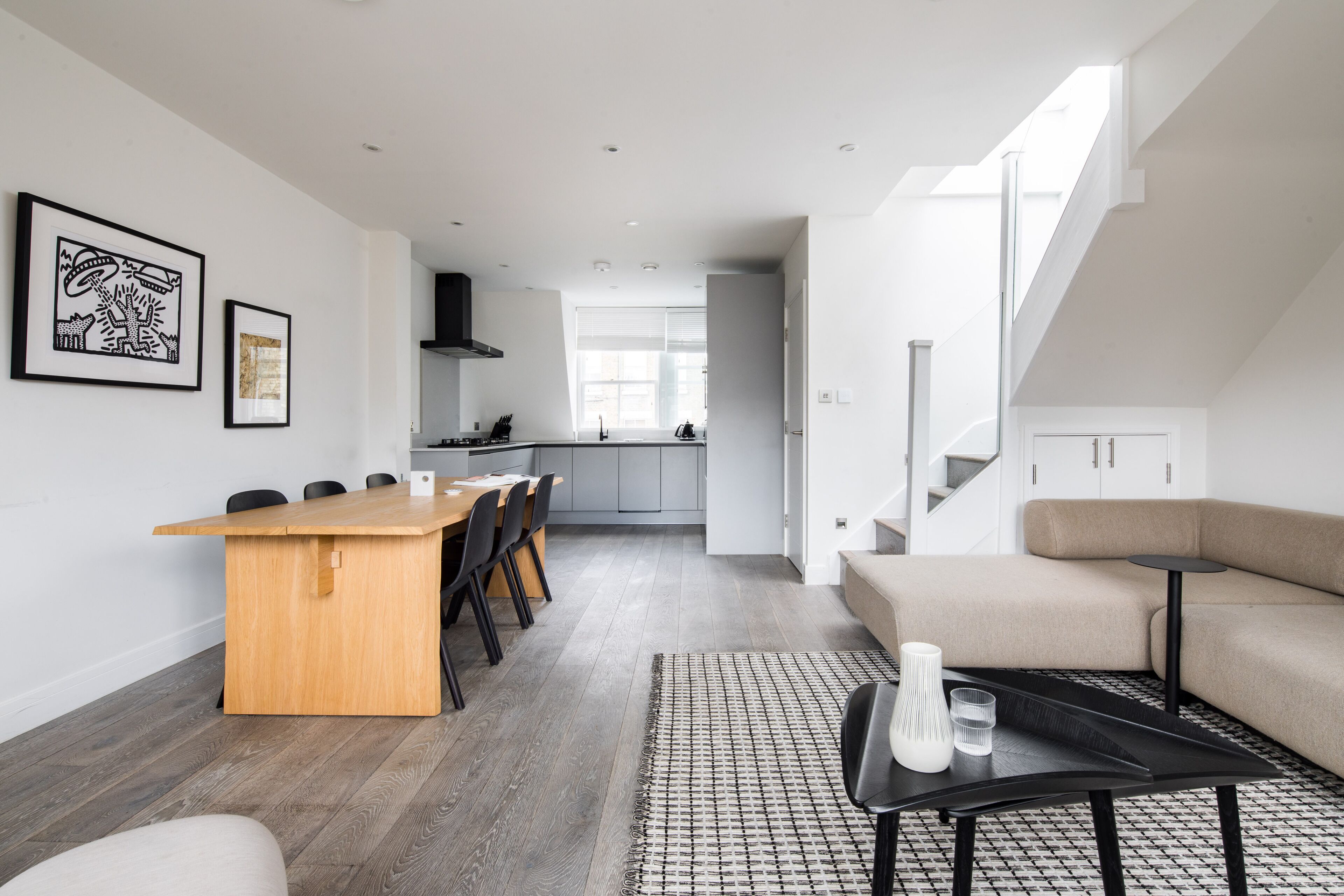 A modern interior with a dining area, kitchen, and living space.