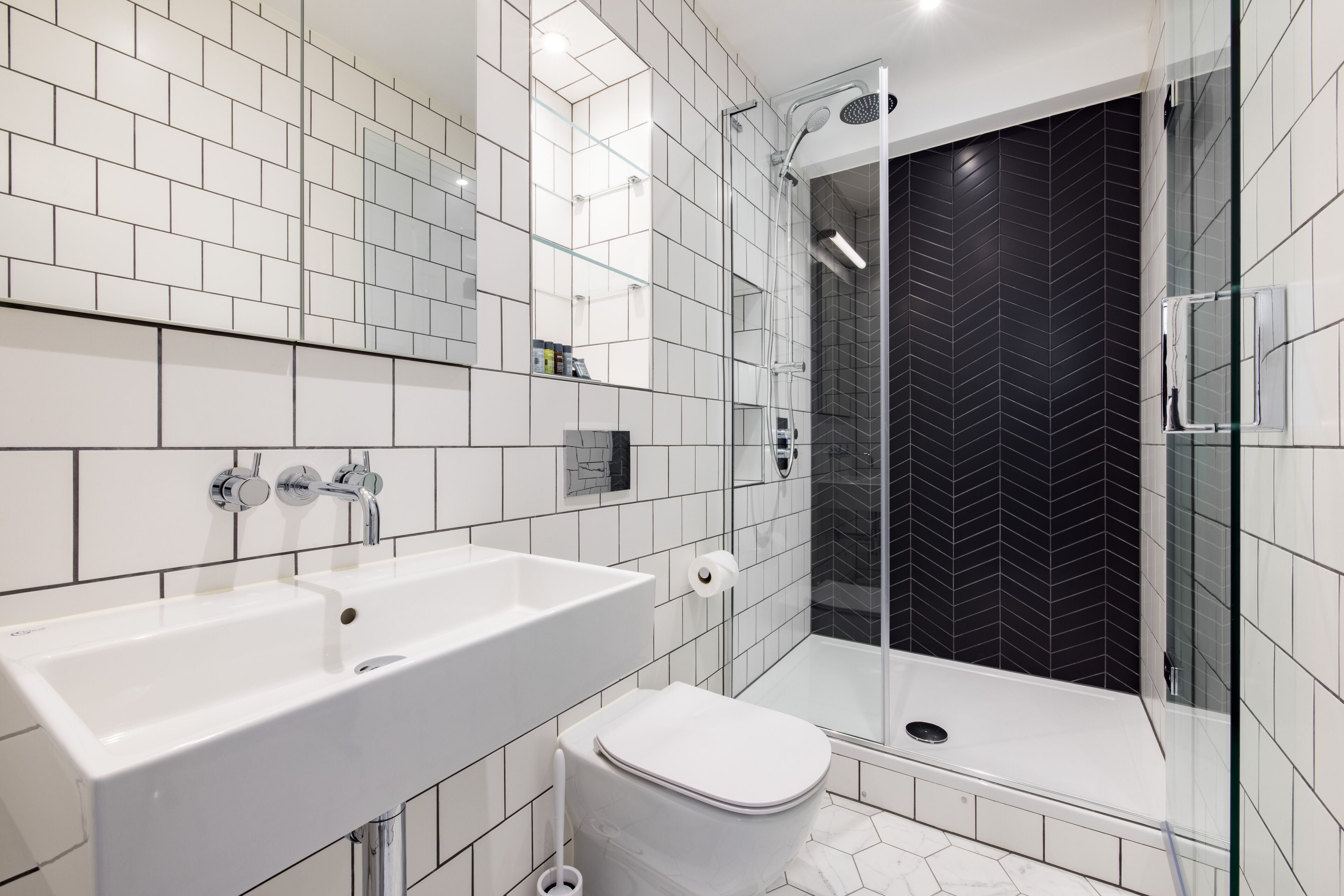 standard suite | bathroom | rainfall showerhead, free toiletries, hair dryer, heated floors