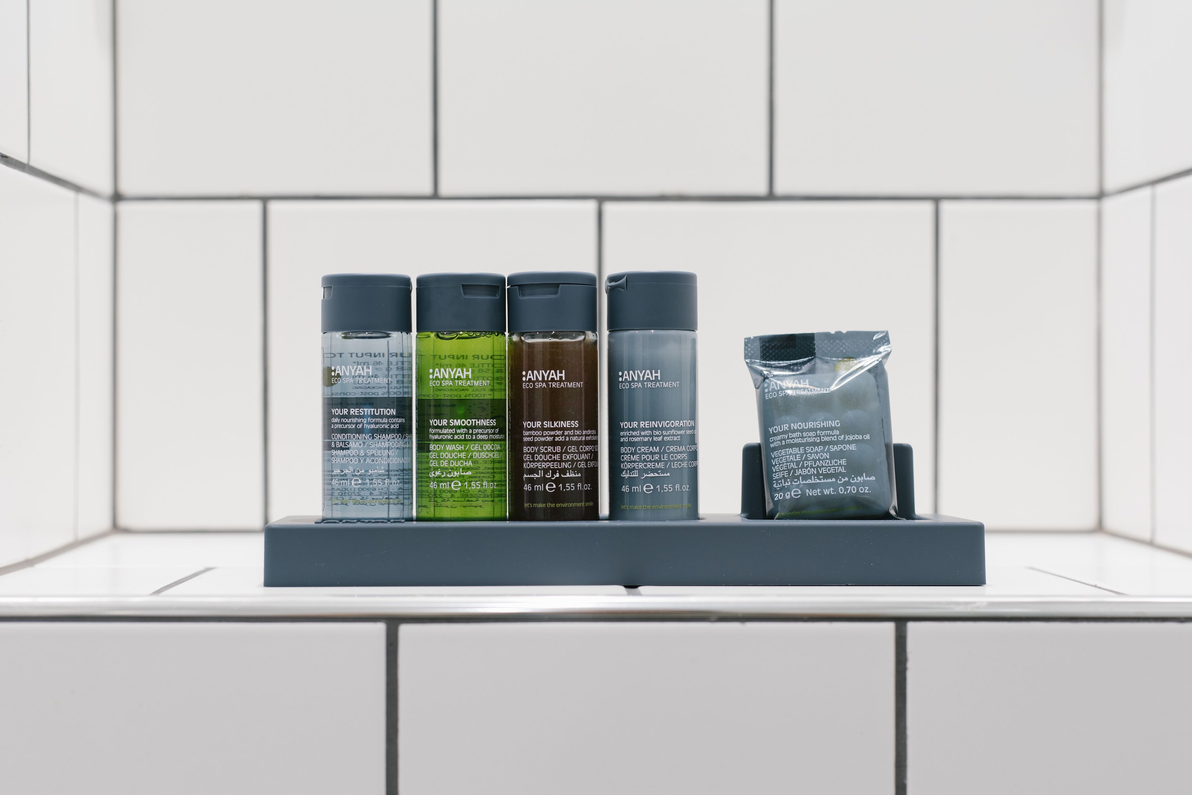 A display of Anyah skincare products on a shelf in a bathroom.
