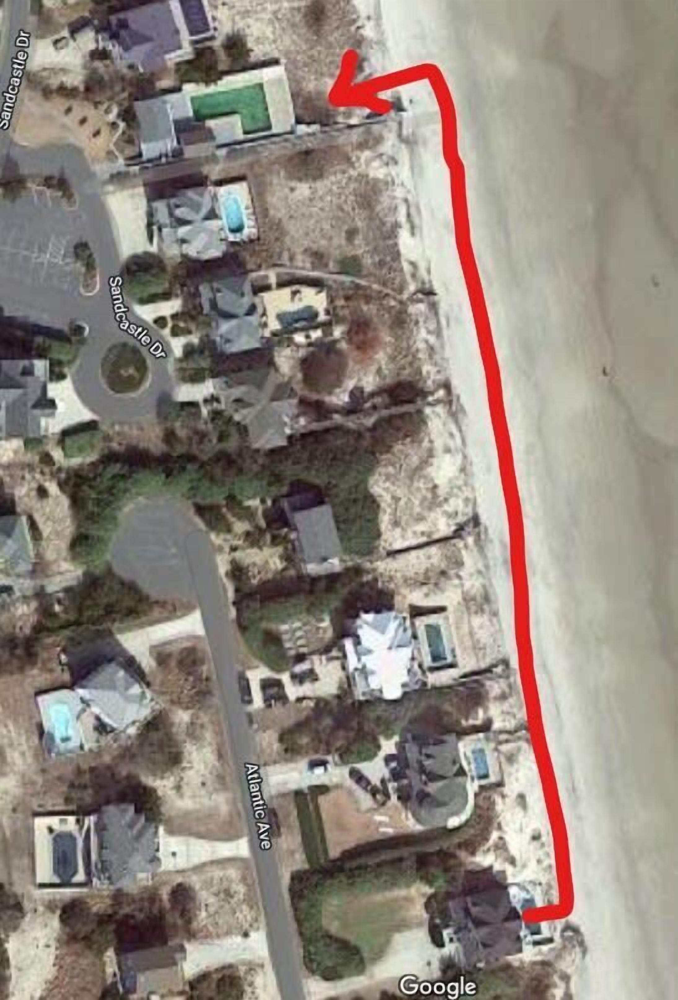 An aerial view of a residential area with houses, a road labeled 'Atlantic Ave', and a beach.