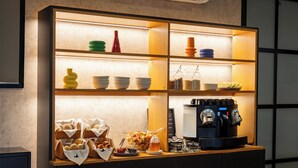 A buffet setup with various food items and a coffee machine. - Urbano FLH Hotels Lisboa (Lisbon)
