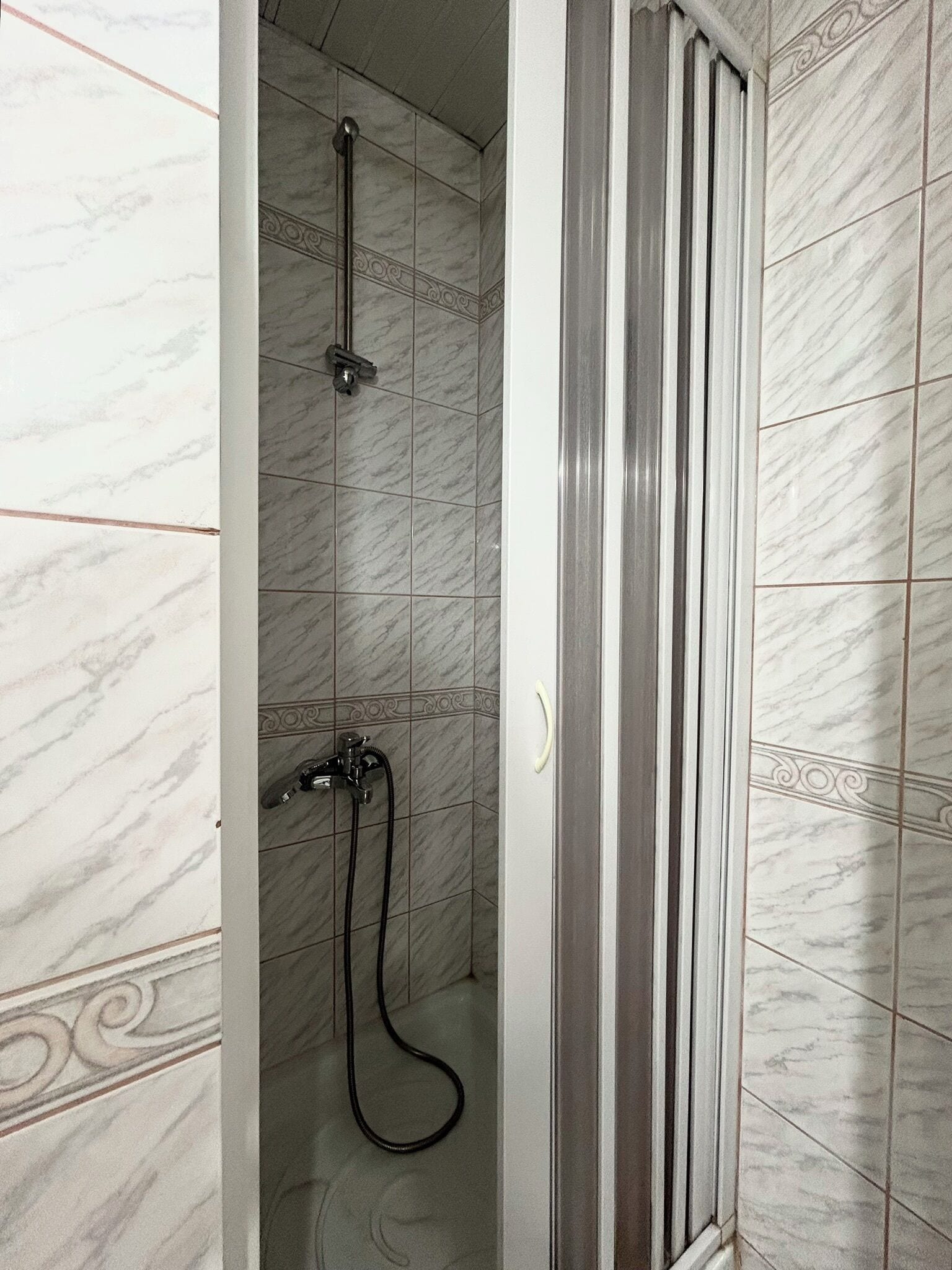 shower, hair dryer, slippers, towels