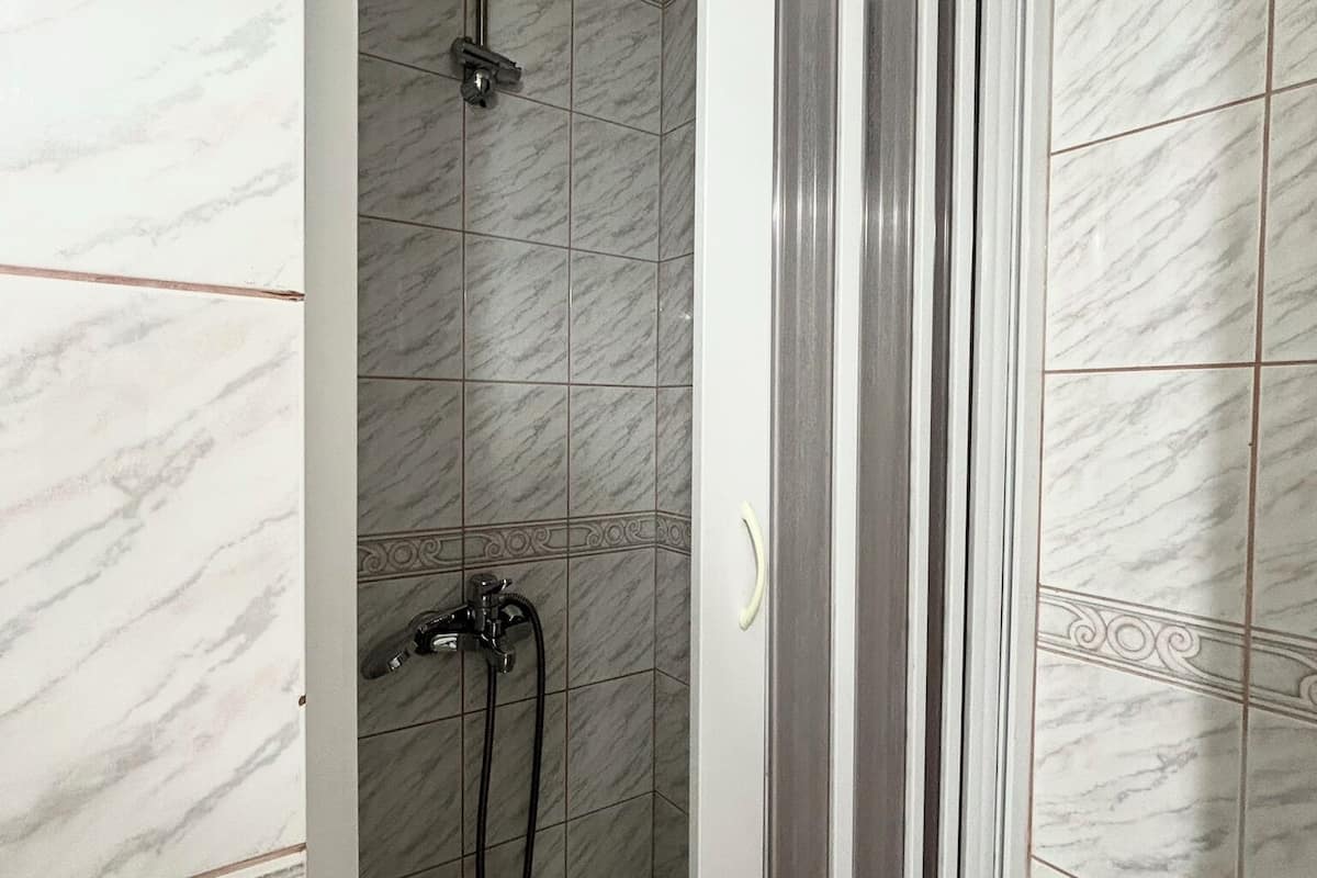 shower, hair dryer, slippers, towels