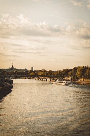 A river with a bridge and a boat.