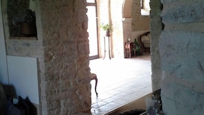 A stone-walled room with a wooden desk and a potted plant. - Antica Taverna del Principe (Sepino)