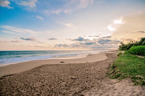 On the beach, white sand, sun loungers, beach towels
