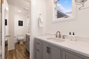 A modern bathroom with a toilet, sink, and vanity. - Little Gem, Prime Location | 1BR + Loft | Walk to Ski & Main Street (Telluride)
