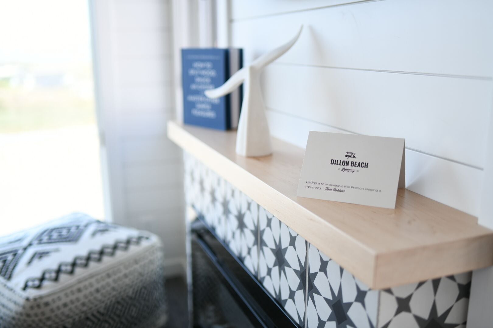 A reception area with a sign for 'Dillon Beach Lodge' and a patterned wall.