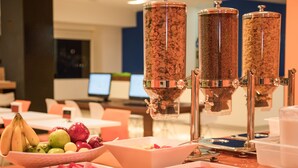 A buffet setup with various food items and a coffee station. - One Irapuato (Irapuato)