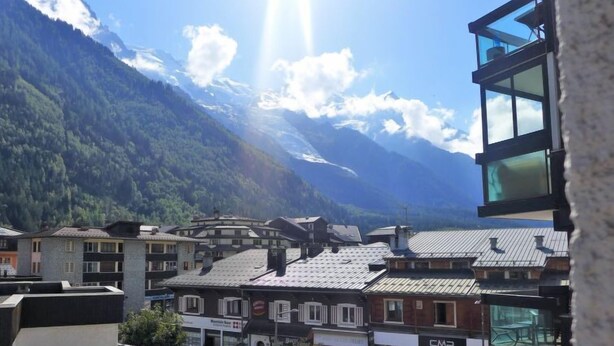 A mountain town with traditional buildings and a modern glass structure. - L'Aiguille du Midi by Interhome (Chamonix)