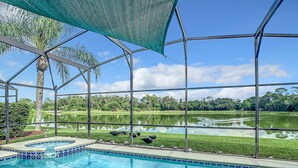 A swimming pool with a view of a lake and surrounding greenery. - MAGIC 5* LAKE VIEW VILLA HEATED POOL&HOT SPA, near DISNEY, 10 Guests (Kissimmee)