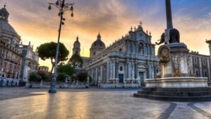 A plaza with a central monument, surrounded by classical architecture.