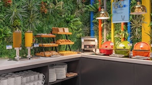 A buffet area with a variety of food items, a coffee station, and a sign promoting classic Chinese dishes.