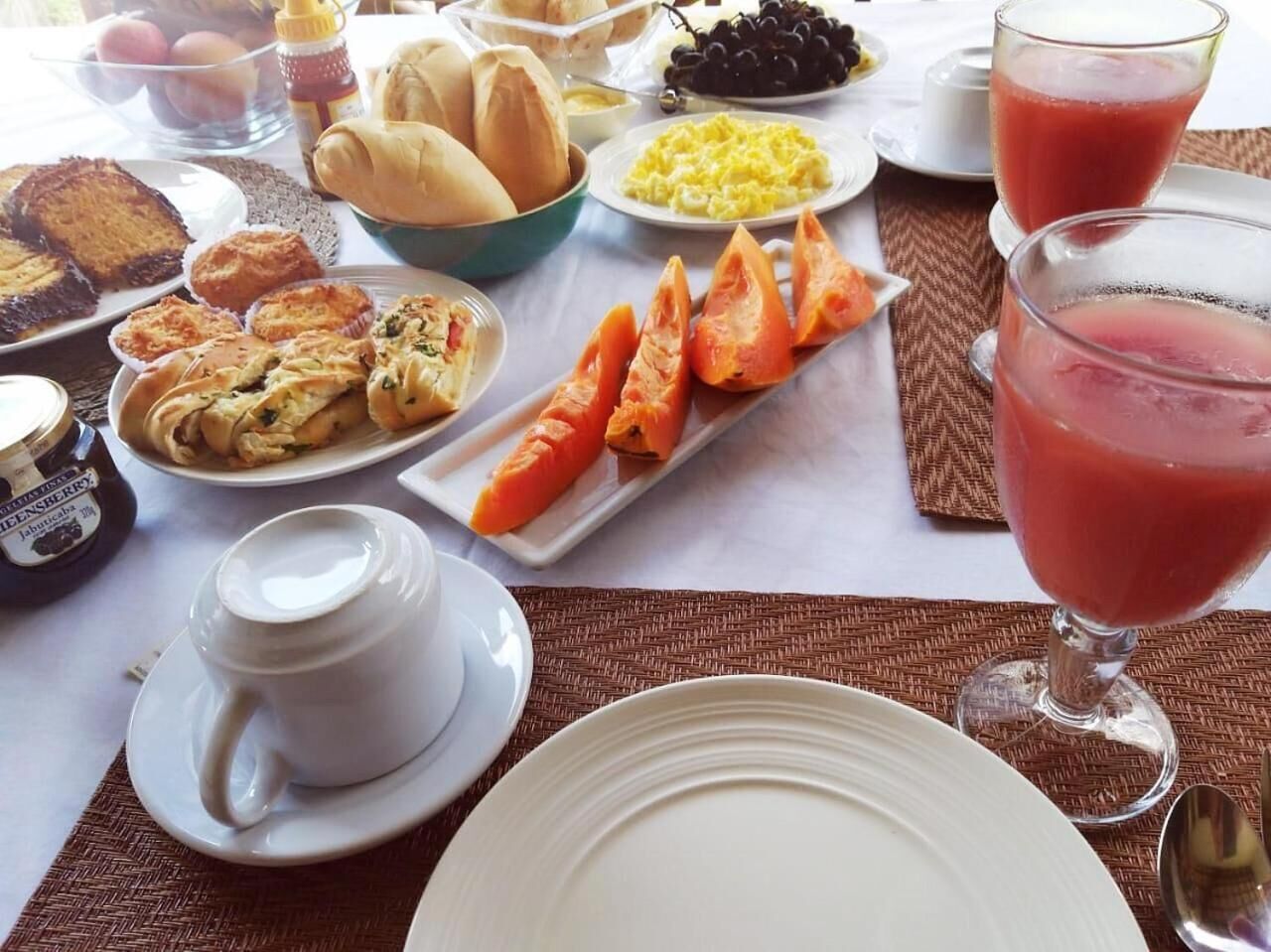 A breakfast buffet with various dishes, including pastries, fruits, and beverages.