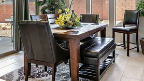 Zona pranzo con tavolo, sedie e lampadario.