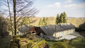 A house with a sloped roof, a visible chimney, and a small porch area.