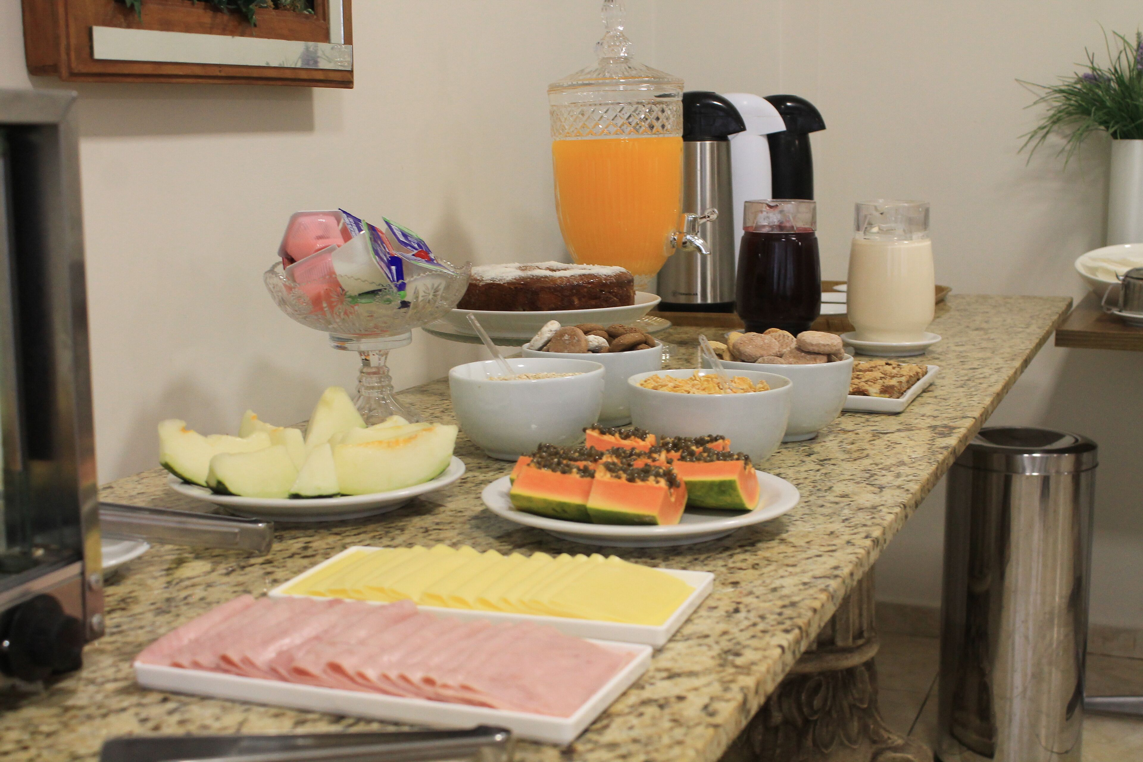 A breakfast buffet with various food items and beverages.