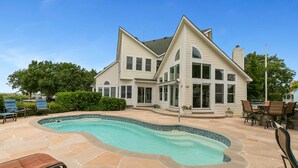 A two-story house with a swimming pool, outdoor seating, and a large lawn. - Sound Escape: Elevator, Hot Tub, Private Pool, Soundfront Location (Corolla)