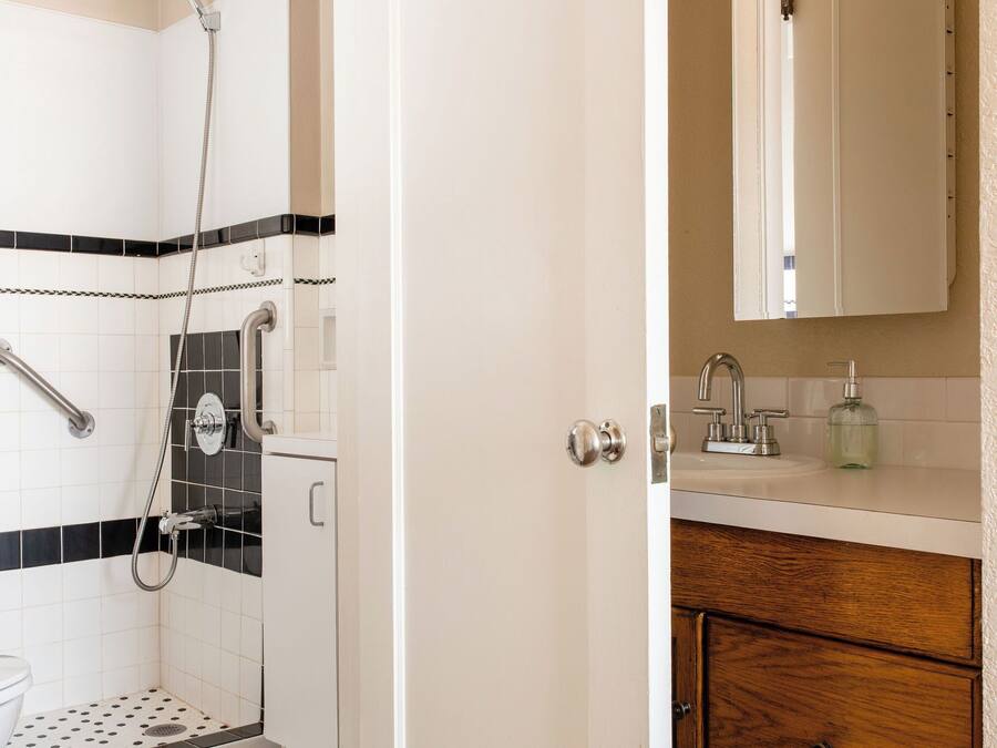 A bathroom with a shower, toilet, and sink.