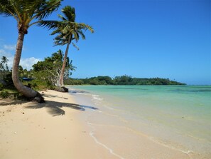 Na praia, espreguiçadeiras, toalhas de praia 