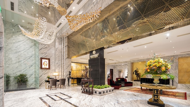 A spacious lobby with marble floors, a reception desk, seating area, and a decorative ceiling. - Anatole Hotel Hanoi (Hanoi)