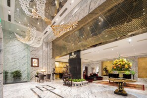 A spacious lobby with marble floors, a reception desk, seating area, and a decorative ceiling. - Anatole Hotel Hanoi (Hanoi)