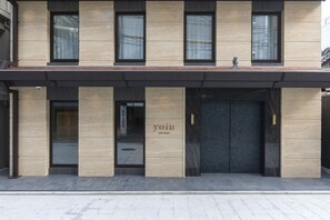 A modern hotel facade with a minimalist design, featuring large windows and a prominent entrance. - Yoin Hotel Kyoto Gion (Kyoto)
