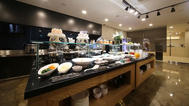 A buffet setup with various dishes and beverages.