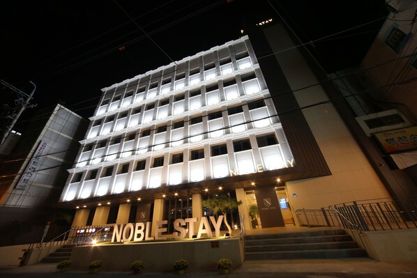 A multi-story building with illuminated signage reading "NOBLE STAY". - Noble Stay (Daegu)