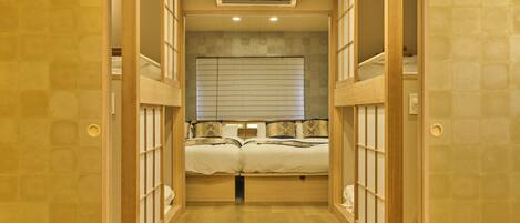 A narrow hallway with a bunk bed at the end.