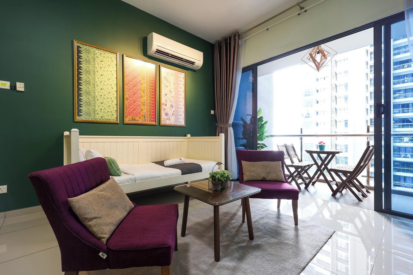 A modern living room with a sofa, two armchairs, a coffee table, and a balcony with a view of a building.
