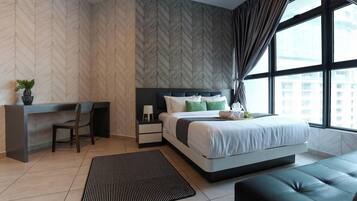 A modern bedroom with a bed, bedside table, and a desk with a chair.
