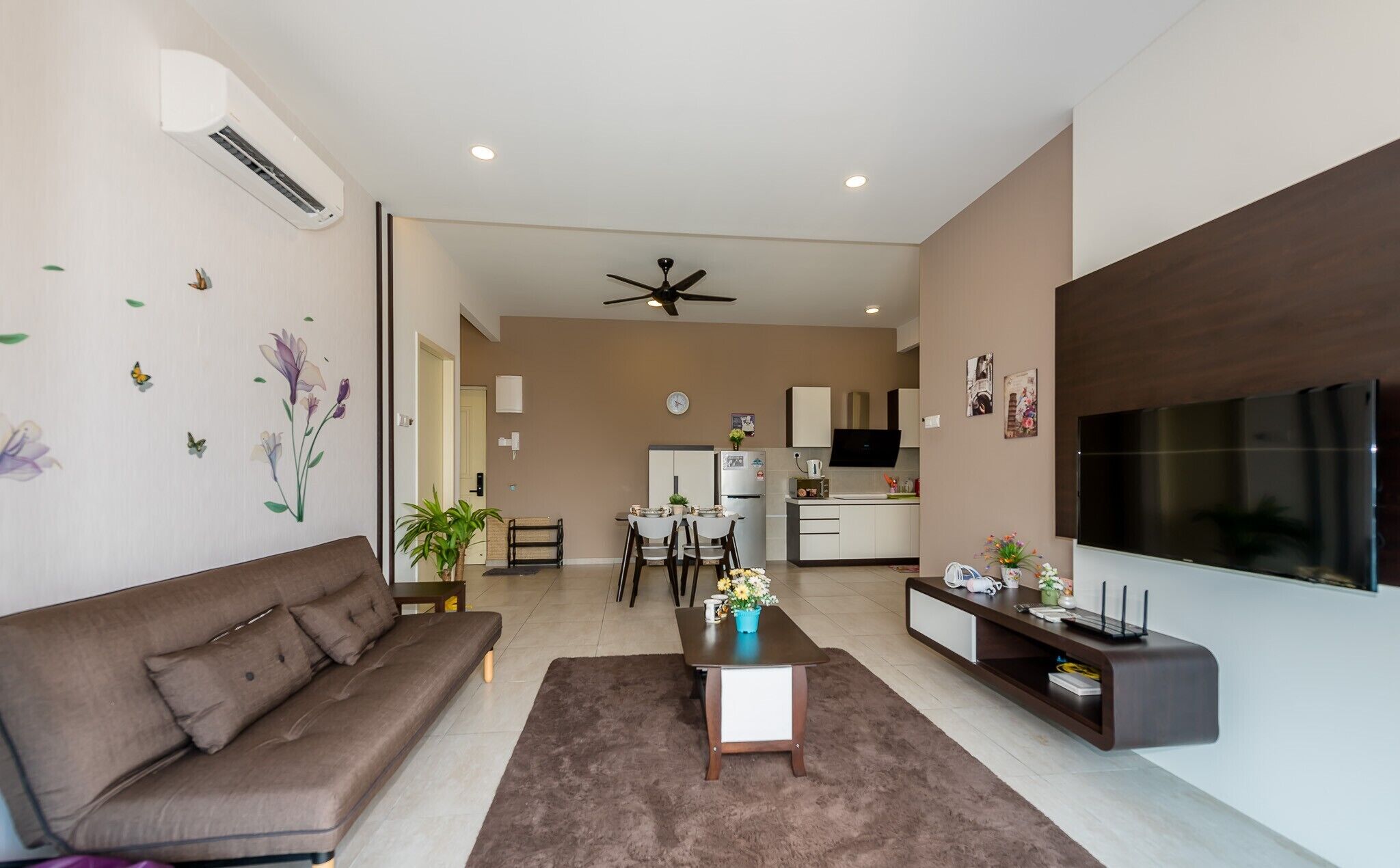 A modern living room with a sofa, a coffee table, and a TV stand.