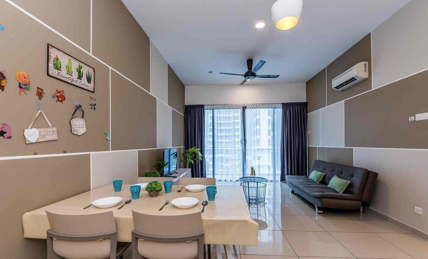 A modern living room with a sofa, a dining table with chairs, and a ceiling fan.