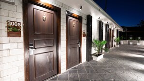 A hotel entrance with two large wooden doors, numbered 3005, and a tiled pathway leading to the entrance. - The Legacy Luxury By Bridge View (Shimla)