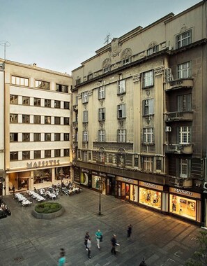 A building with multiple floors, featuring a ground-floor restaurant named 'MAJESTIC' and several retail stores including 'MAX&Co.' on the ground level. - Hotel Majestic (Belgrade)