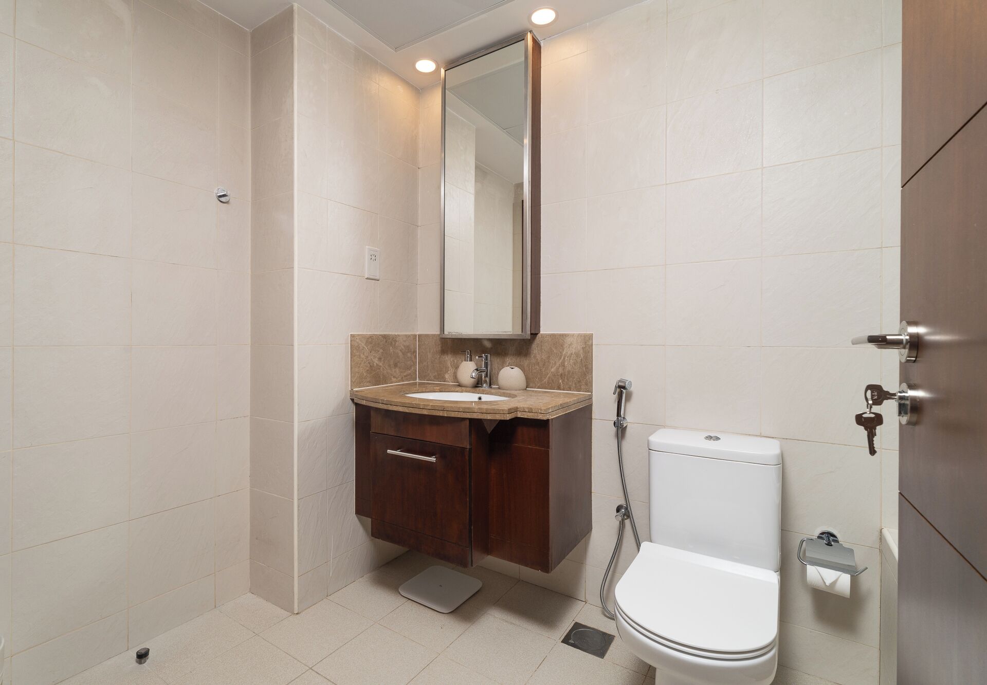 A modern bathroom with a toilet, sink, and shower.
