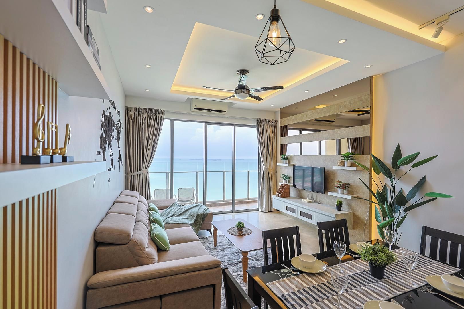 A modern living room with a sofa, dining table, and TV.