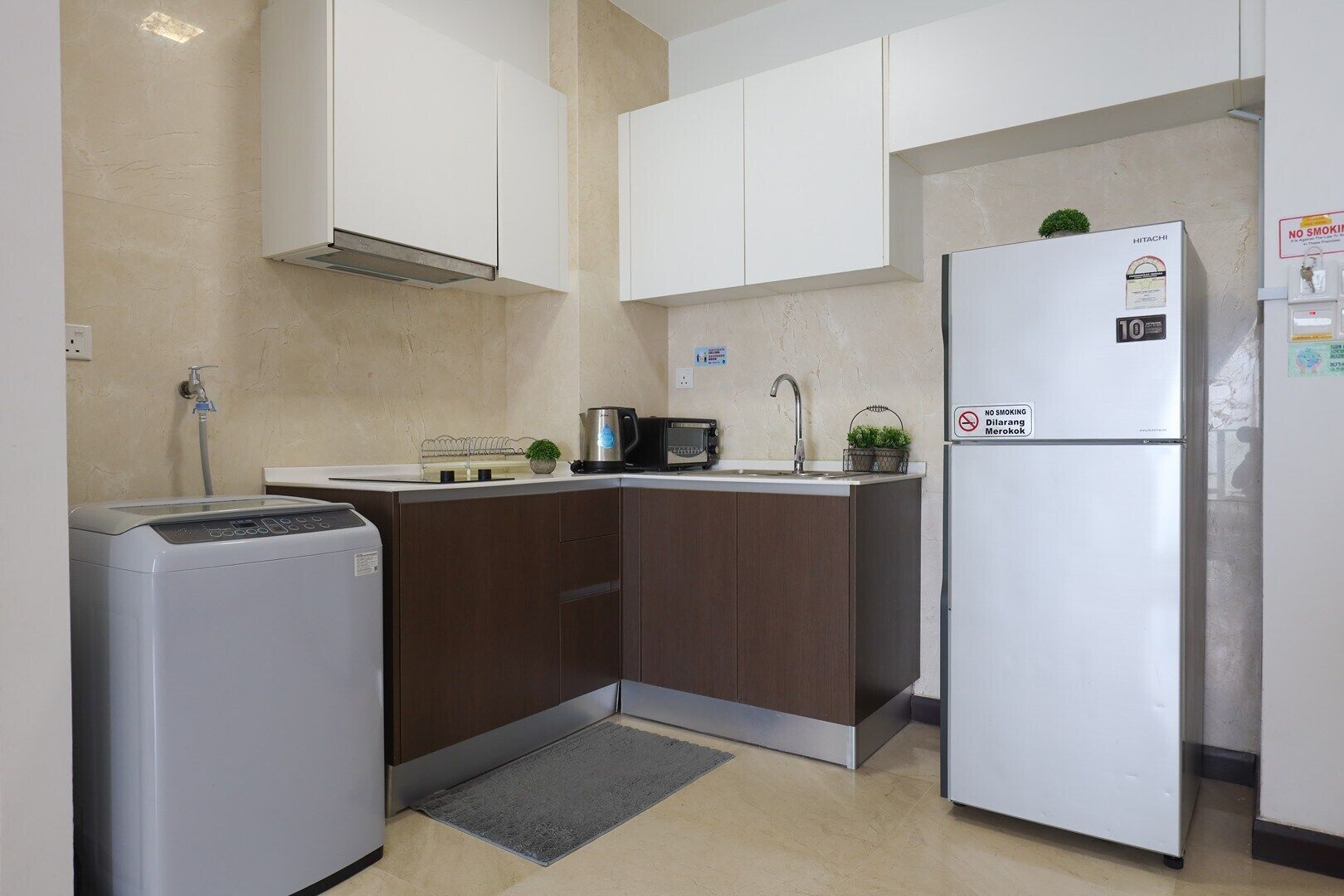A compact kitchen with a built-in microwave, a refrigerator, and a sink.