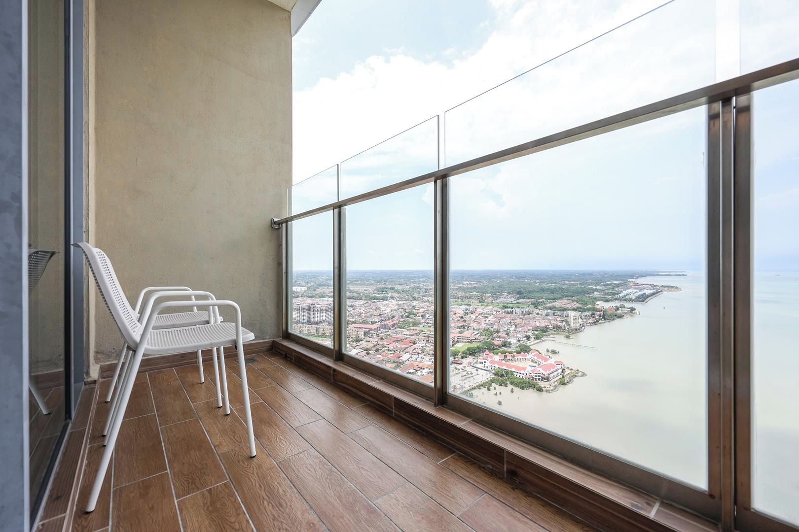 A balcony with a view of a city and a river.