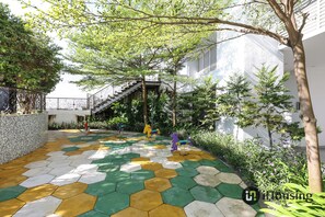 A courtyard with a colorful hexagonal tile floor, a staircase, and a tree. - Silverscape Executive Melaka by I Housing (Malacca City)