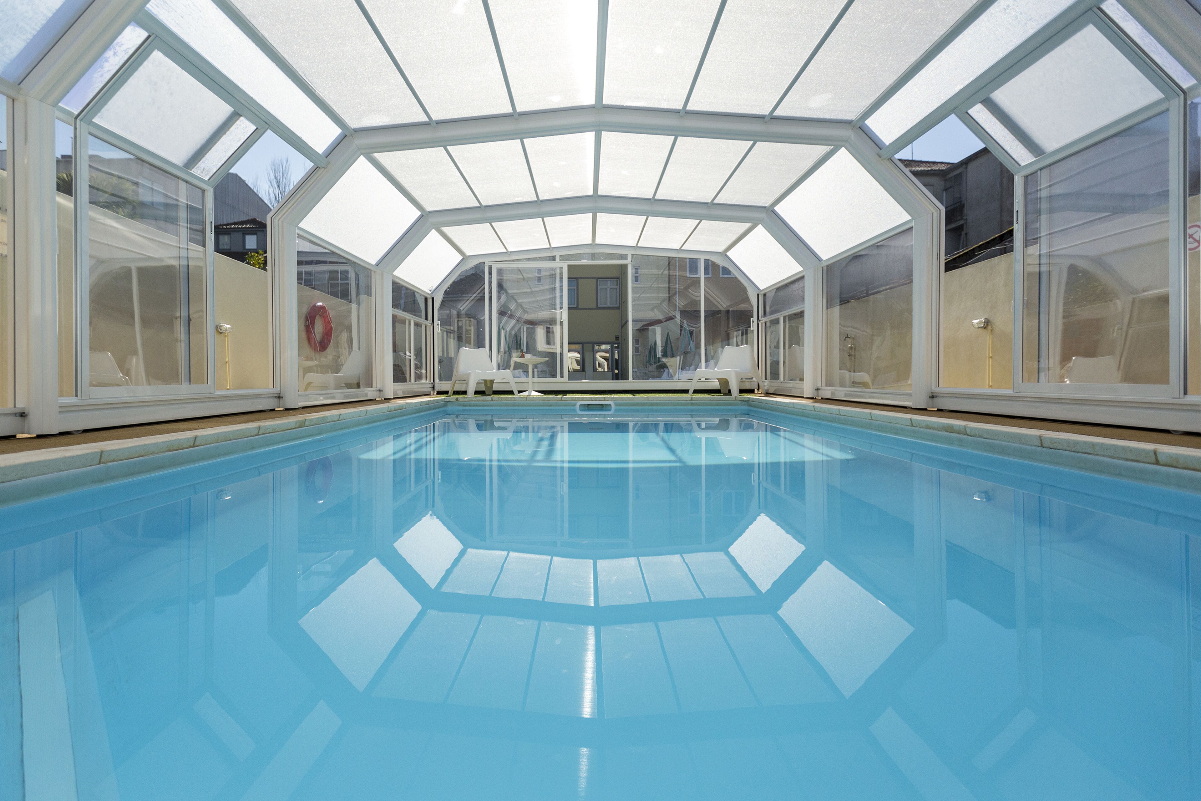 Indoor pool, open 10:00 AM to 7:00 PM, pool umbrellas, pool loungers