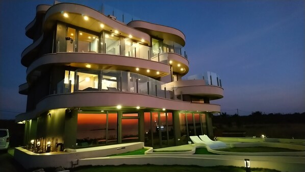 A multi-story modern house with balconies, large windows, and a swimming pool area. - Laguna Villas & Resorts (Magong)