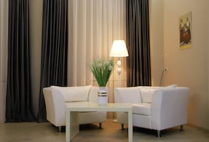 Relax in this stylish living room with two sofas, a coffee table, and a floor lamp.