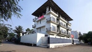 A multi-story building with balconies, a flat roof, and a gated entrance. - Dean Villa (Mawal)