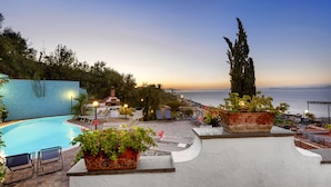 A rooftop pool area with lounge chairs, a swimming pool, and potted plants. - Villa Bianca (Sorrento)