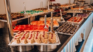 A buffet with various desserts and pastries.
