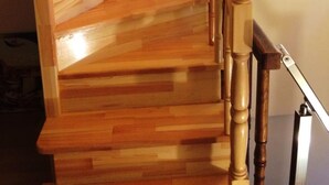A wooden staircase with a handrail and a picture on the wall. - Emirhan Hotel - Adults Only (Istanbul)