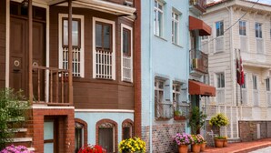 A street with multi-story buildings, potted plants, and cobblestone pavement. - Emirhan Hotel - Adults Only (Istanbul)