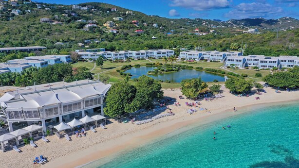 A resort with a beach, pool, and buildings with a view of the surrounding hills. - WOW! 3 BR! Remodeled waterfront unit, Sapphire Beach, ocean view, private patio (St Thomas)